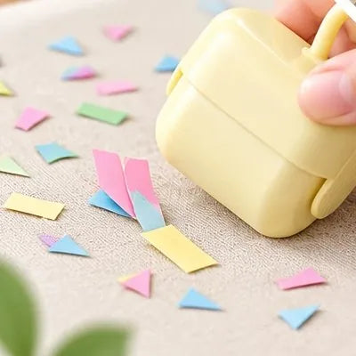 Roller collecting paper confetti from fabric