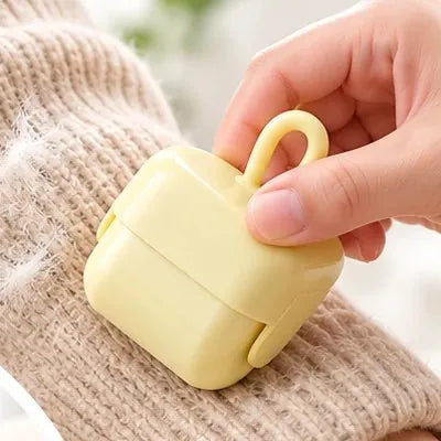 Roller removing fuzz from a knit sweater